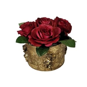 Floral Arrangement. Round gold paper mache container with embossed cherubs/roses